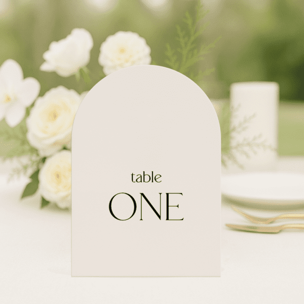 Evermore wedding table number in arch shape featuring romantic, modern fonts and soft colour palette, styled for an elegant reception table.