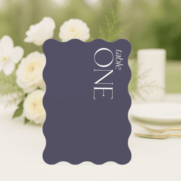 Sam wedding table number in wave shape featuring romantic, modern fonts and soft colour palette, styled for an elegant reception table.