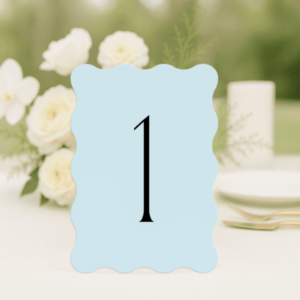 Tori wedding table number in wave shape featuring romantic, modern fonts and soft colour palette, styled for an elegant reception table.