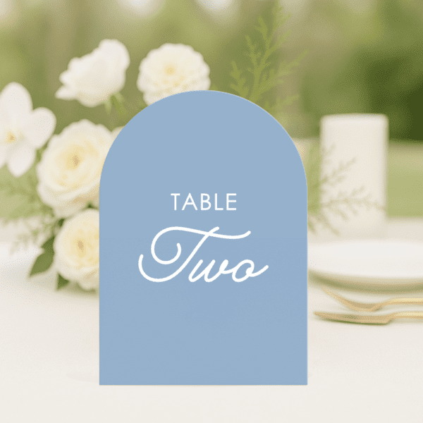 Love Bug wedding table number in arch shape featuring romantic, modern fonts and soft colour palette, styled for an elegant reception table.
